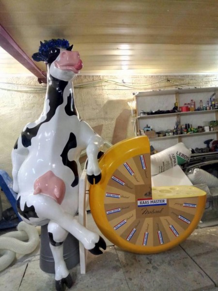 Advertising plastic sculpture of a cow with cheese