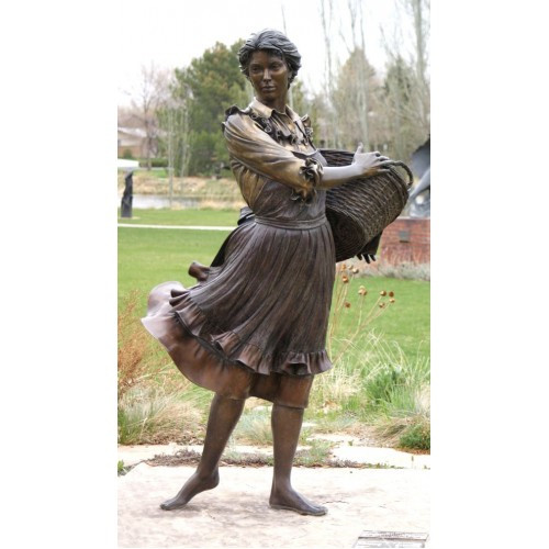 Bronze sculpture of a woman with a basket